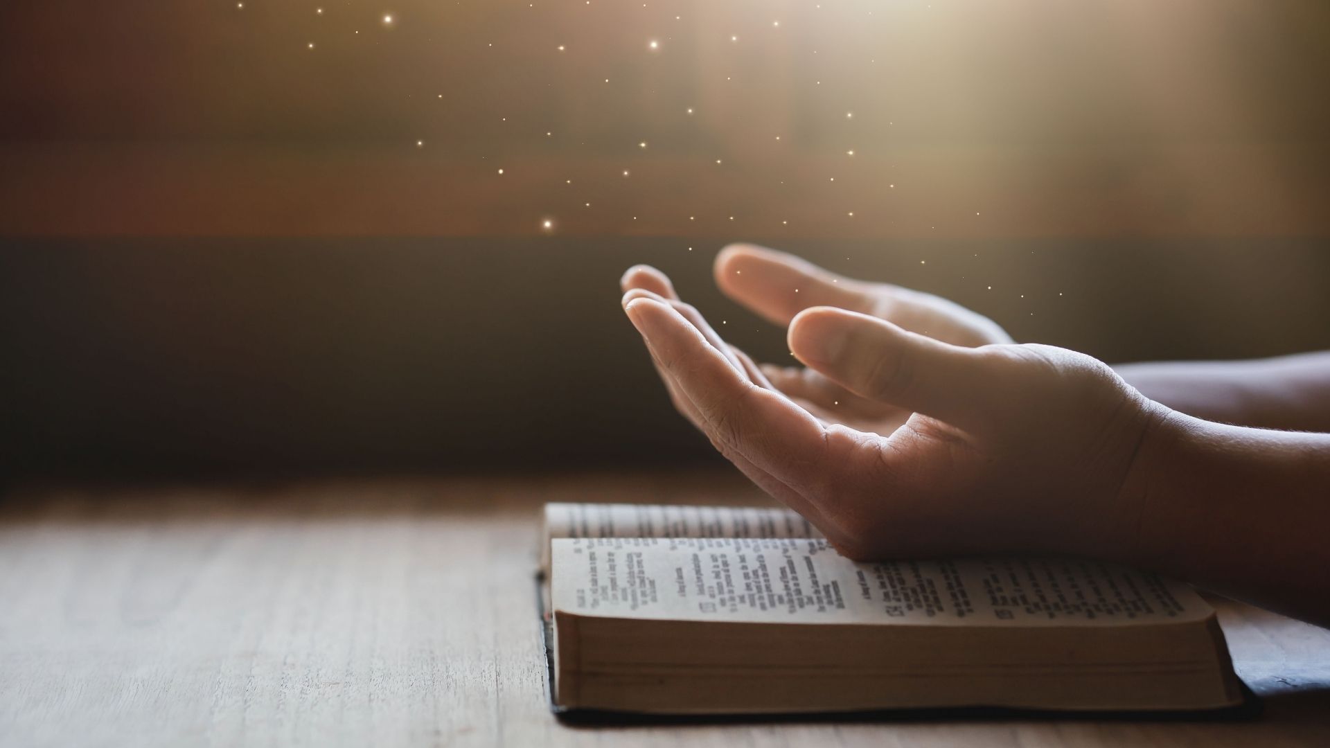 hands on bible worshiping the light